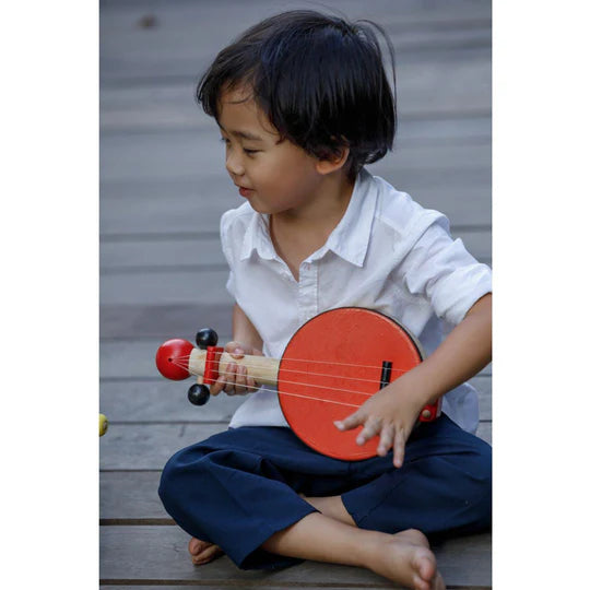 Enfant avec Banjo rouge en bois et caoutchouc