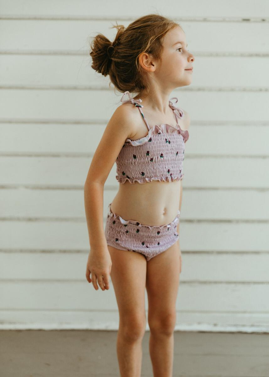 little girl wearing fin & vince ss22 tulips smocked bikini purple lavender