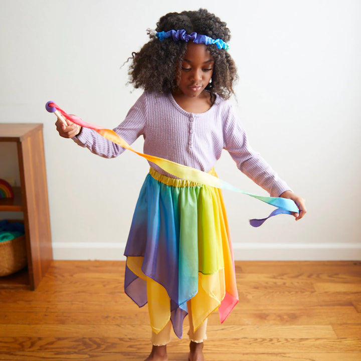 Fille avec Mini baguette en soie arc-en-ciel