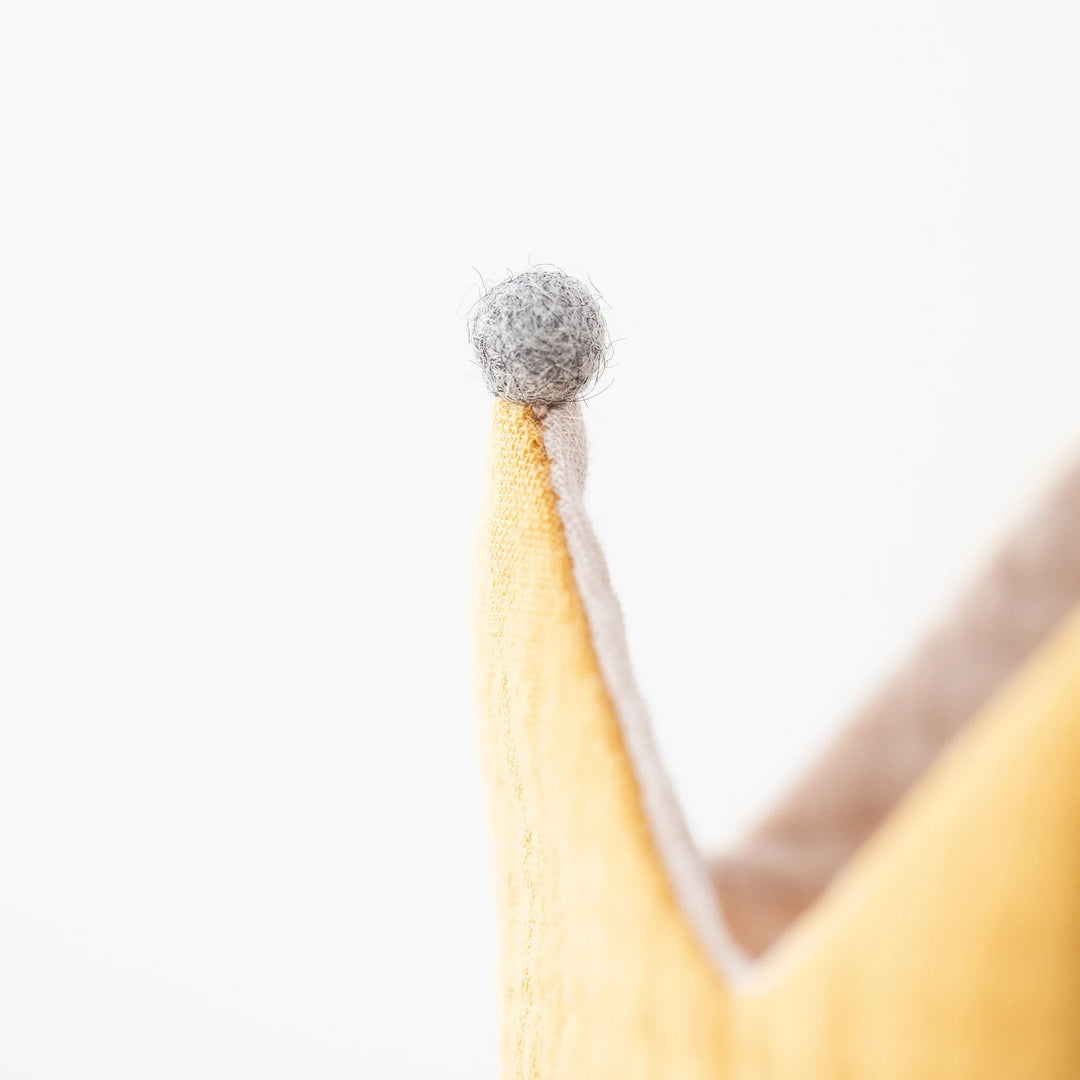 Couronne réversible en tissu jaune et écru avec pompons gris