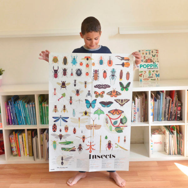 kid holding insect poster